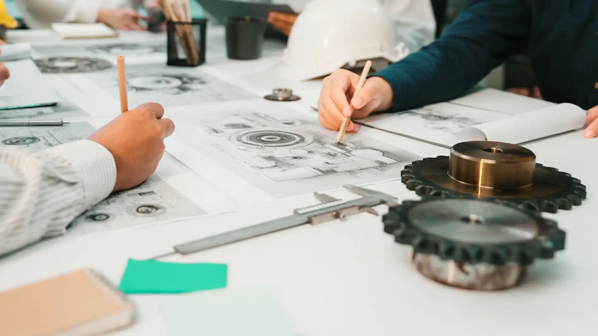 A collaborative group of engineers and professionals analyzing technical drawings in a modern workspace, illustrating the strategic shift from Korean-style marketing to US B2B marketing standards.
